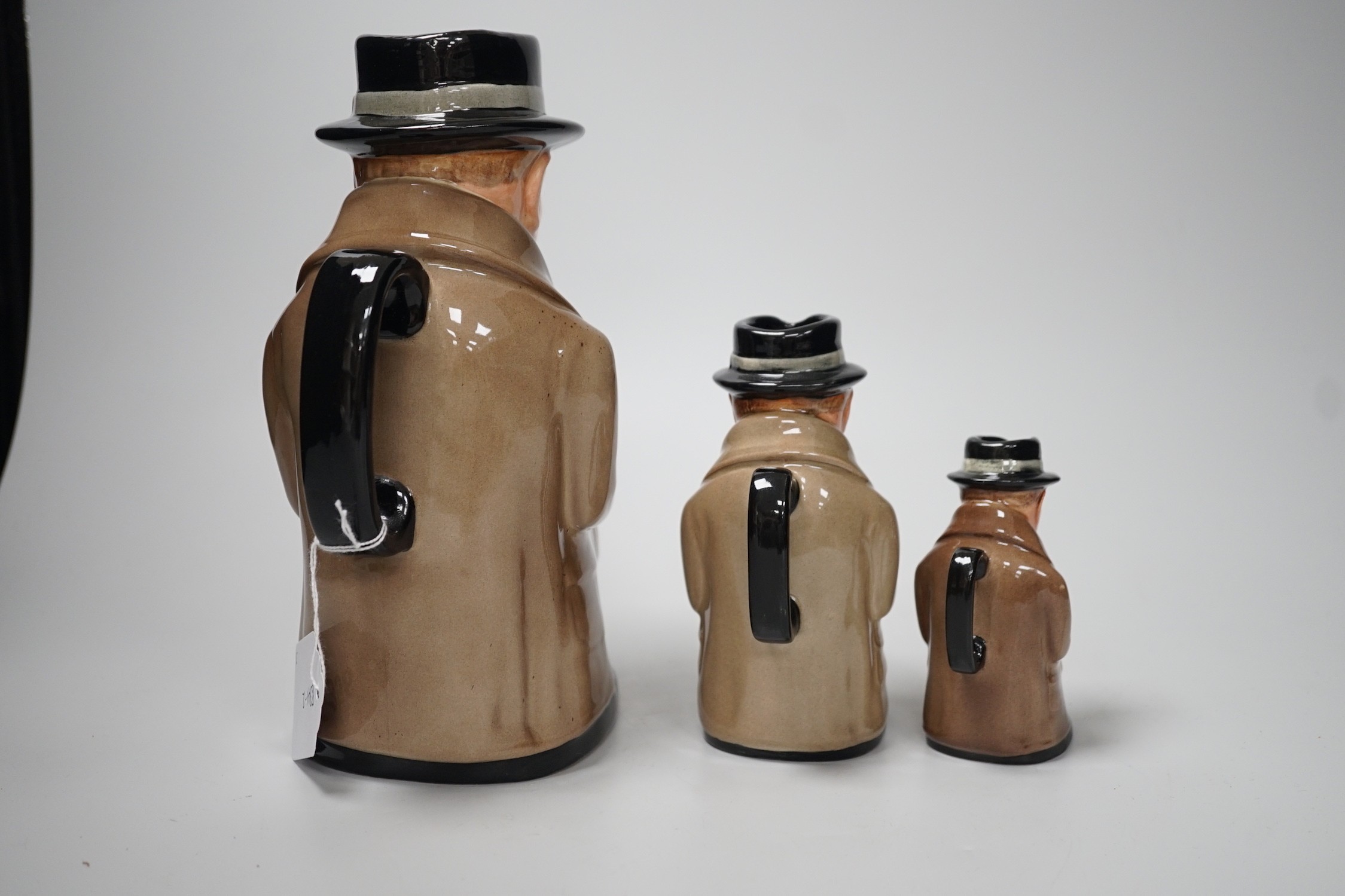 Three graduated Royal Doulton 'Churchill' character jugs, 23cm